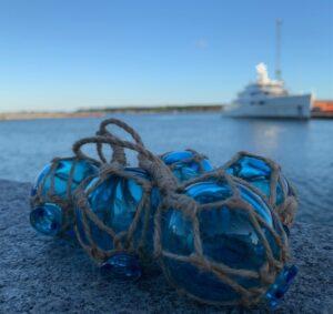 turqoise glass floats on topes for hanging nautical decor